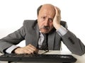 Business man with bald head on his 60s working stressed and frustrated at office computer laptop desk looking tired Royalty Free Stock Photo