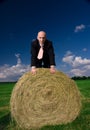 Business man on a bale of hay Royalty Free Stock Photo