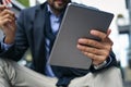 Business man baying over credit card and using iPod. Royalty Free Stock Photo