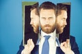 Business man with beard, holding mirror with face reflection Royalty Free Stock Photo