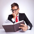 Business man being affraid by the book Royalty Free Stock Photo