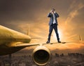 Business man and binoculars lens standing on plane wing spying Royalty Free Stock Photo