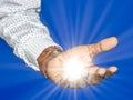 Business man black hand as if holding something with light ray. Focus on finger tips. Image