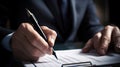 Business man in black suit signing contract document with digital tablet on office desk, deal concept, close up Royalty Free Stock Photo