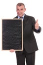 Business man with blackboard shows thumb up Royalty Free Stock Photo