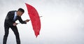 Business man blocking rain with umbrella against white background Royalty Free Stock Photo