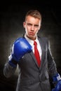 Business man in blue boxing gloves Royalty Free Stock Photo