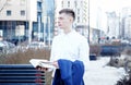 Business man. A man with a book and a laptop. The guy speaks through the phone on the street. The guy in the glasses makes notes i Royalty Free Stock Photo