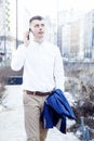 Business man. A man with a book and a laptop. The guy speaks through the phone on the street. The guy in the glasses makes notes i Royalty Free Stock Photo