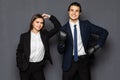 Business man with boxing gloves with a young business woman isolated on gray background Royalty Free Stock Photo