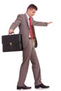 Business man with briefcase balancing