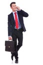 Business man with briefcase talking on the phone Royalty Free Stock Photo