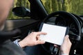 Business man browsing tablet and showing the blank mobile screen inside the car Royalty Free Stock Photo