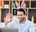 Business man, bunny ears and laptop with video call, wave and smile for contact, networking and festive fashion