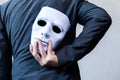 Business man carrying white mask to his body indicating Business fraud and faking business partnership Royalty Free Stock Photo