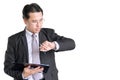 Business man checking time. people holding job broad and pen looking at his wrist watch. Handsome man standing on Royalty Free Stock Photo