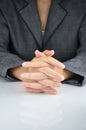 A business man with an clasp hand to contemplate Royalty Free Stock Photo