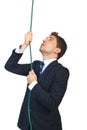 Business man climbing a rope