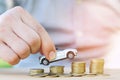 Business man and close up hand holding model of toy car on over a lot money of stacked coins - insurance, loan and buying car fina Royalty Free Stock Photo