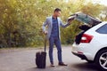 Business man closes car trunk Royalty Free Stock Photo