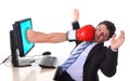 Business Man with computer hit by boxing glove Royalty Free Stock Photo