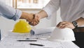 Business man and construction engineer shaking hands after finish an agreement in the home office, success collaboration concept Royalty Free Stock Photo