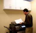 Business man at copy machine Royalty Free Stock Photo