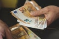 Business man counting money. rich male hands holds and count cash banknotes of 50 euros bills or notes currency. Royalty Free Stock Photo