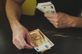 Business man counting money. rich male hands holds and count cash banknotes of 50 euros bills or notes currency. Royalty Free Stock Photo