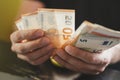 business man counting money. rich male hands holds and count cash banknotes of 50 euros bills or notes currency. Royalty Free Stock Photo