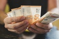 Business man counting money. rich male hands holds and count cash banknotes of 50 euros bills or notes currency. Royalty Free Stock Photo