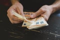 Business man counting money. rich male hands holds and count cash banknotes of 50 euros bills or notes currency. Royalty Free Stock Photo