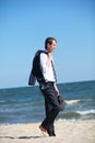 business man dealing with emotional stress walking on the beach