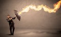 Business man defending himself from a fire arrow with an umbrella Royalty Free Stock Photo