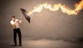 Business man defending himself from a fire arrow with an umbrella Royalty Free Stock Photo