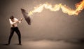 Business man defending himself from a fire arrow with an umbrella Royalty Free Stock Photo