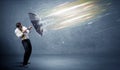 Business man defending light beams with umbrella concept Royalty Free Stock Photo