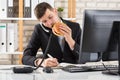 Business Man At Desk Eating Burger And Working Royalty Free Stock Photo