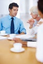 Business man in discussion with senior citizen. Portrait of young business man discussing with senior executive in