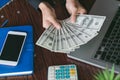 Business man displaying a spread of cash over, spending money o Royalty Free Stock Photo