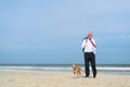 Business man with dog at the beach Royalty Free Stock Photo