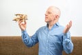 Business man dreams about his achievement to fly. Business dream concept. A man holds a wooden airplane model in his hands Royalty Free Stock Photo