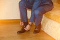 Business man dressing up with classic, elegant shoes. Groom wearing on wedding day, tying the laces and preparing Royalty Free Stock Photo