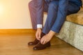 Business man dressing up with classic, elegant shoes. Groom wearing on wedding day, tying the laces and preparing Royalty Free Stock Photo