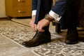 Business man dressing up with classic, elegant shoes. Groom wearing on wedding day, tying the laces and preparing Royalty Free Stock Photo