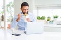 Business man eating asian food from delivery while working using computer laptop at the office Royalty Free Stock Photo