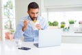 Business man eating asian food from delivery while working using computer laptop at the office Royalty Free Stock Photo