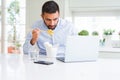 Business man eating asian food from delivery while working using computer laptop at the office Royalty Free Stock Photo