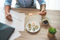 Business man eating sushi at lunch time while working at new project - Senior entrepreneur inside creative studio - Smart work and Royalty Free Stock Photo