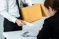 Business man employee holding brown cardboard box and sending a letter of resignation to the executive Royalty Free Stock Photo